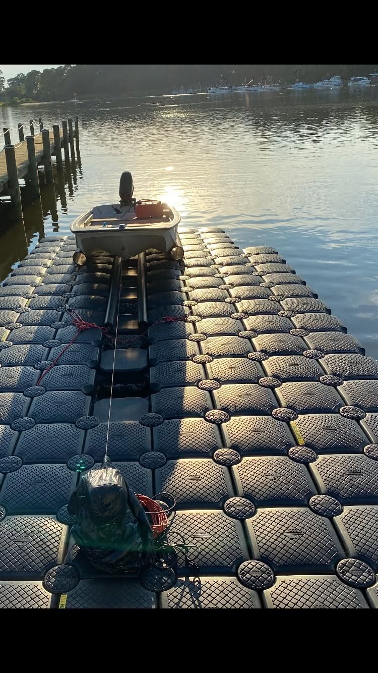 A1 Docks gallery photo of a small boat on a floating dock at sunrise