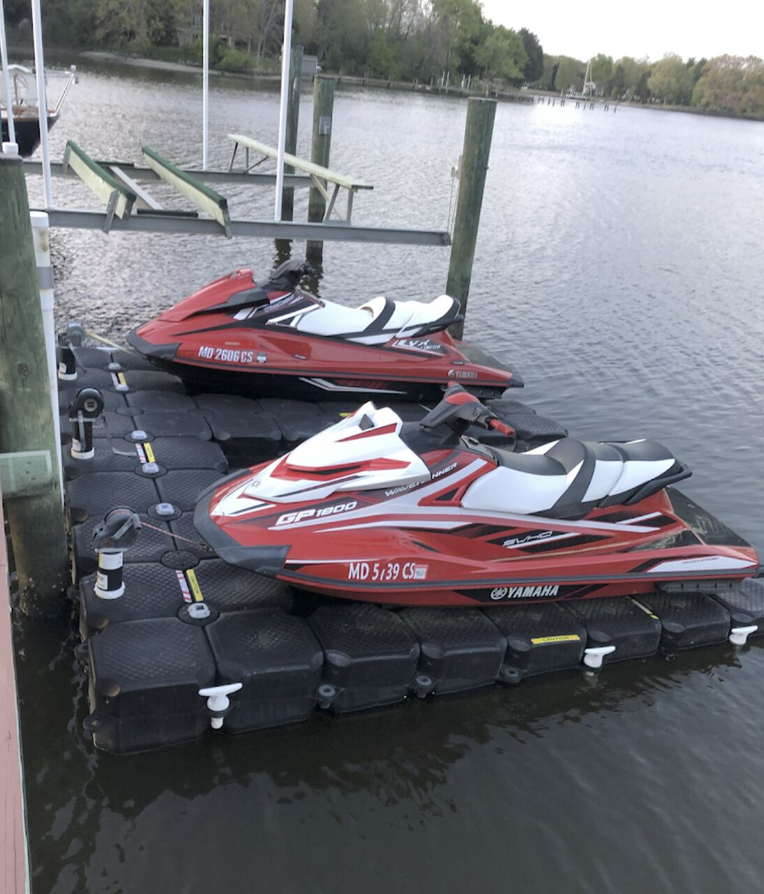 Two jet skis secured on a floating jet ski dock