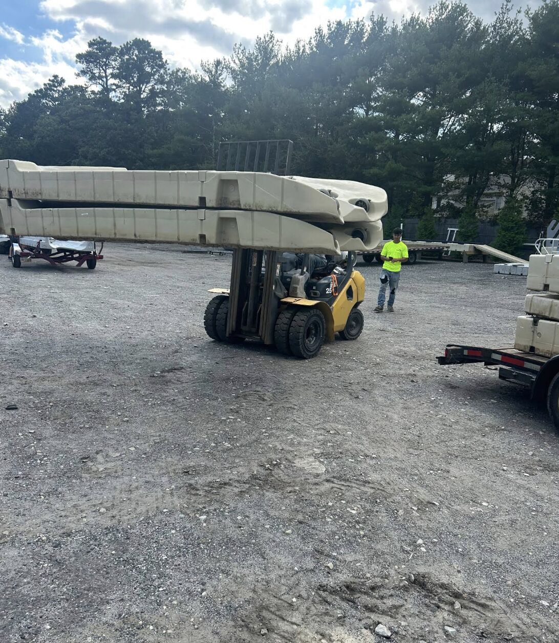 A1 Docks team refurbishing floating dock sections in the yard